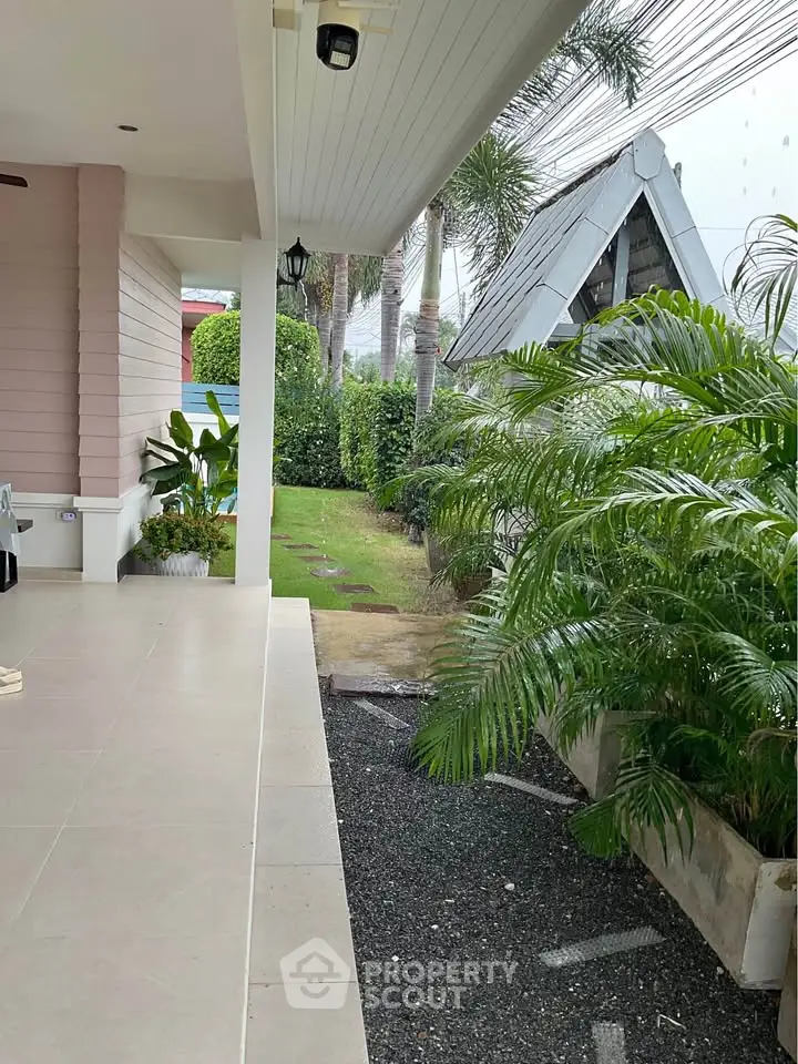 Charming garden view from a modern patio with lush greenery and elegant landscaping.
