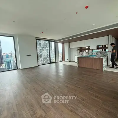 Spacious modern living room with open kitchen and city view in luxury apartment