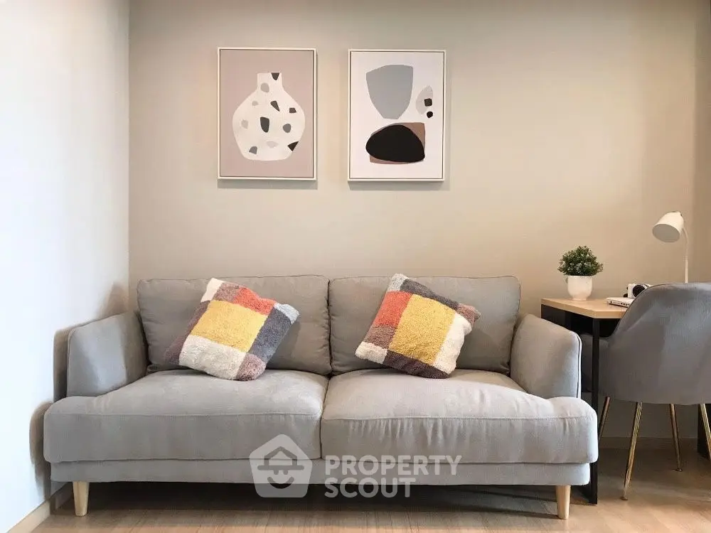Cozy living room with modern sofa, abstract art, and stylish decor