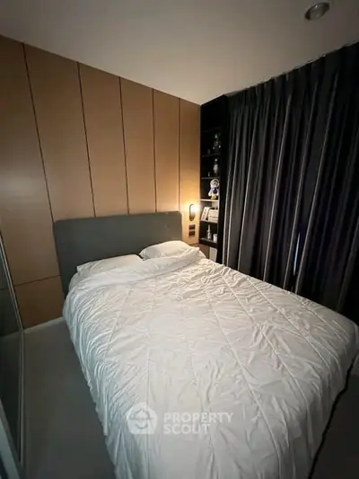 Cozy modern bedroom with elegant wood paneling and soft lighting, perfect for restful nights.