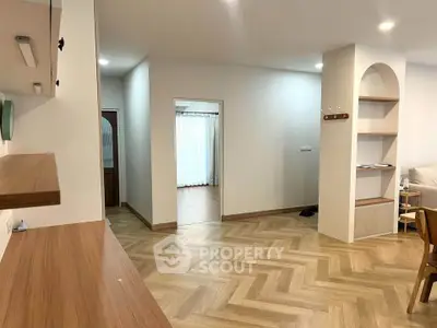 Spacious modern living area with wooden flooring and open layout