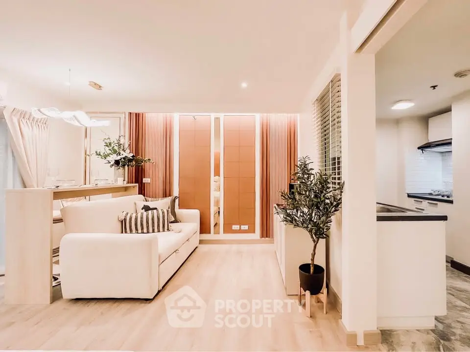 Modern living room with elegant decor and open kitchen layout