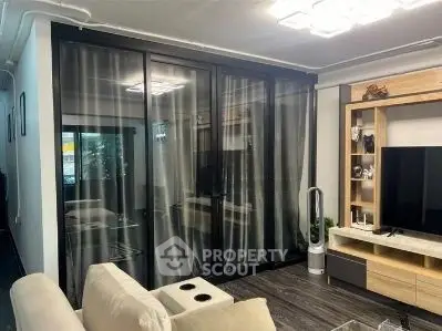 Modern living room with sleek glass doors and stylish entertainment center