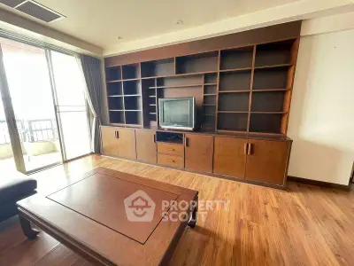 Spacious living room with wooden flooring and built-in entertainment unit