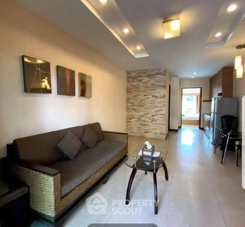 Modern living room with stylish decor and open layout, featuring a cozy sofa and elegant lighting.