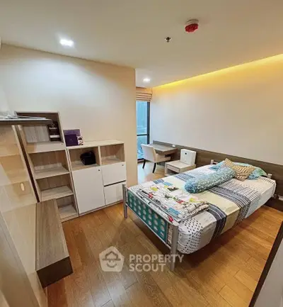 Modern bedroom with stylish decor and wooden flooring in a cozy apartment.