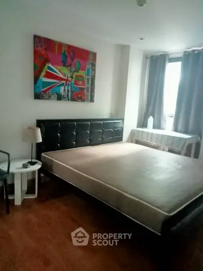 Spacious bedroom with modern art and natural light