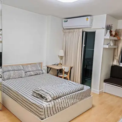 Cozy bedroom with modern decor and balcony access in a stylish apartment.