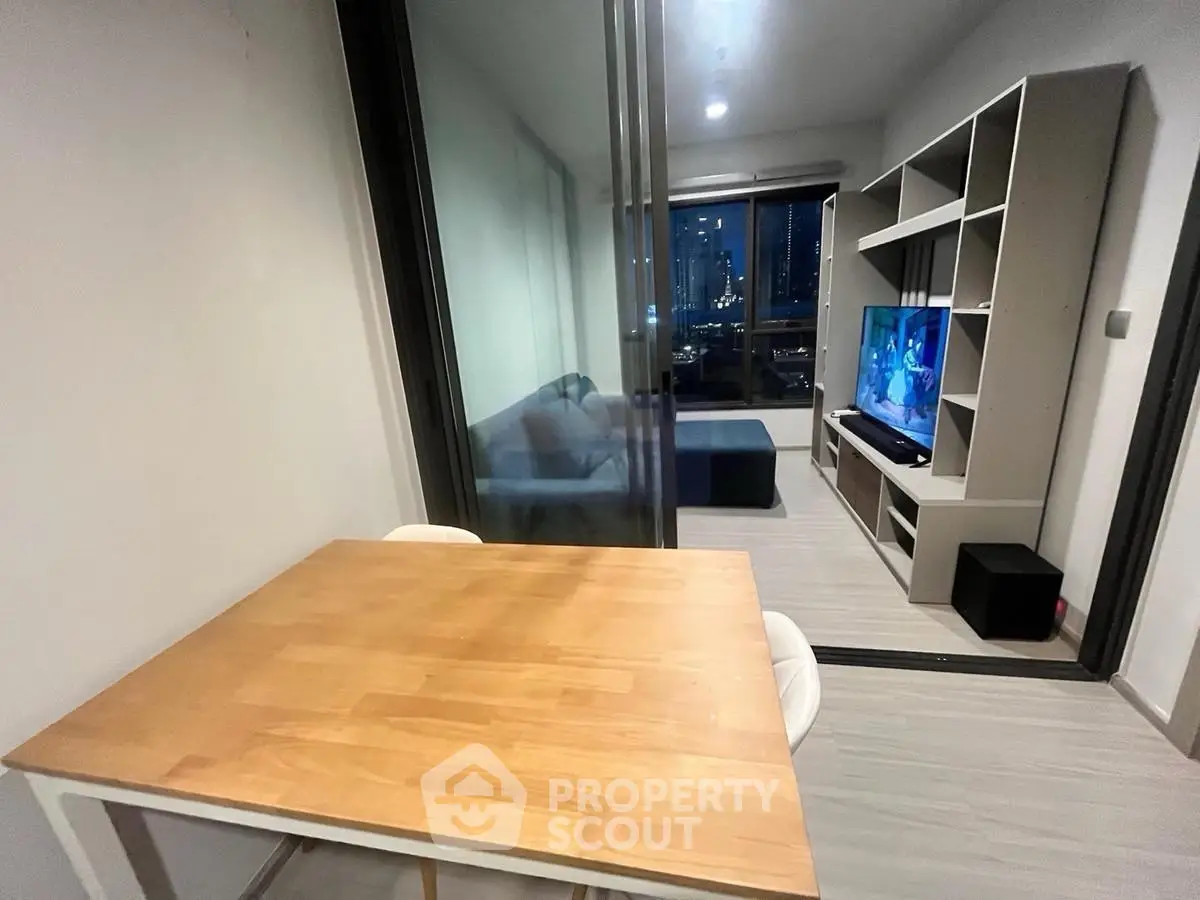 Modern living room with sleek furniture and city view, perfect for urban living.