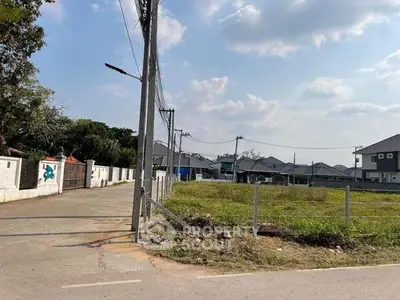 Charming suburban neighborhood with spacious plots and modern homes under a clear blue sky.