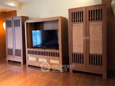 Elegant living room with wooden furniture and modern TV setup