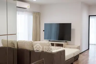 Modern living room with large TV and comfortable sofa in a bright apartment