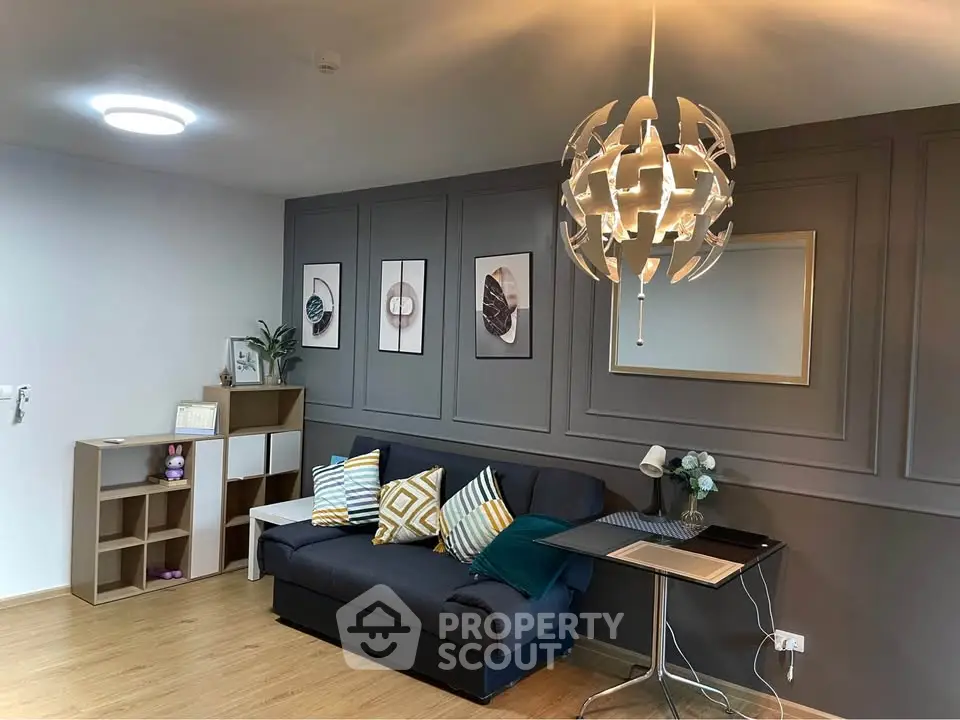 Stylish living room with modern lighting and cozy sofa, perfect for relaxation and entertaining.