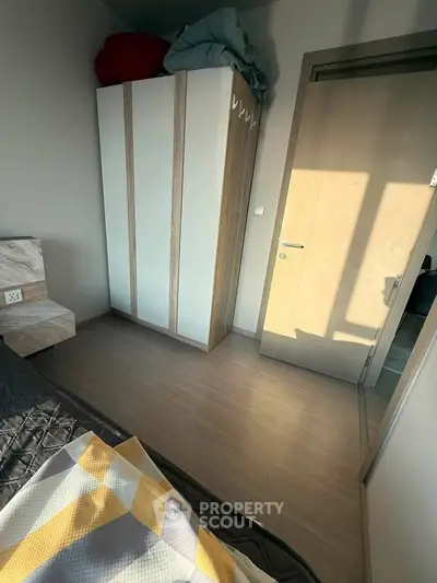 Cozy bedroom with modern wardrobe and natural light