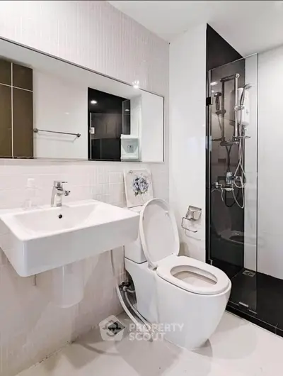 Modern bathroom with sleek fixtures and glass shower enclosure