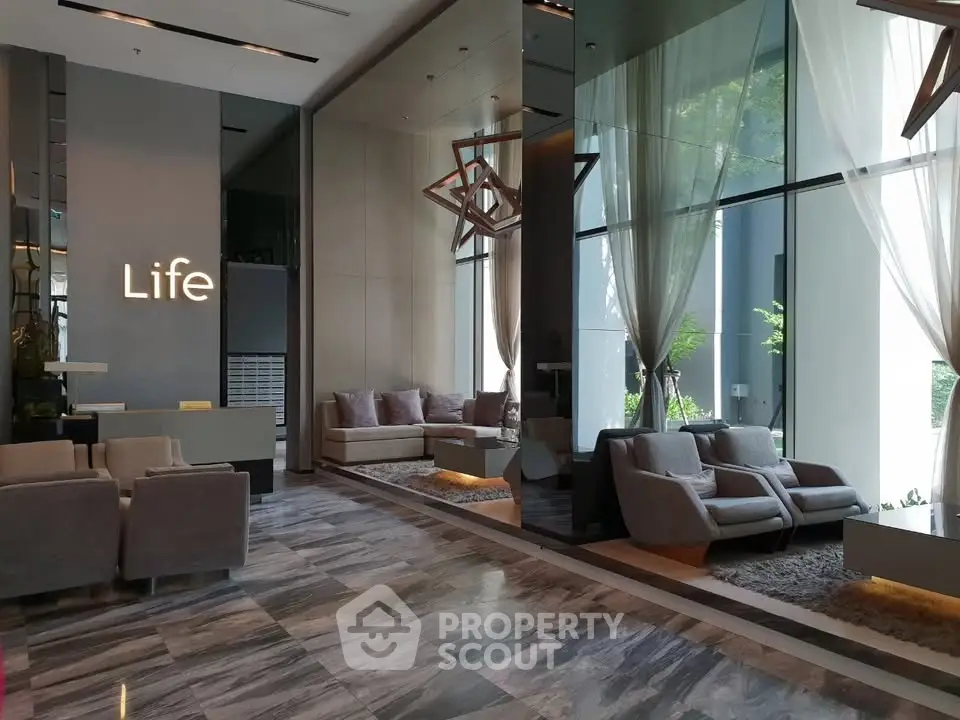 Luxurious modern lobby with elegant seating and floor-to-ceiling windows in a high-end building.