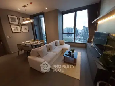 Luxurious modern living room with city view, elegant decor, and spacious seating area.