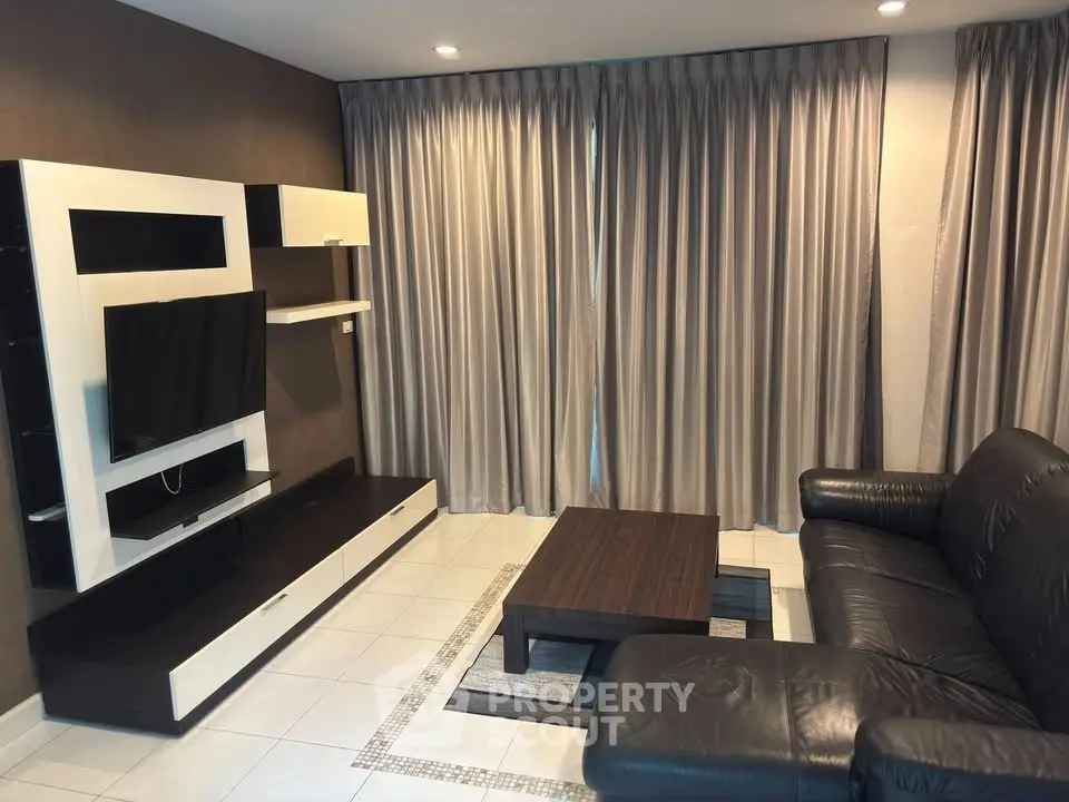 Modern living room with sleek furniture and large TV setup