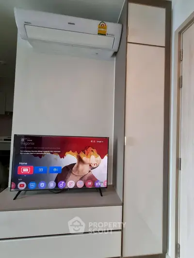 Modern living room with sleek TV and air conditioning unit