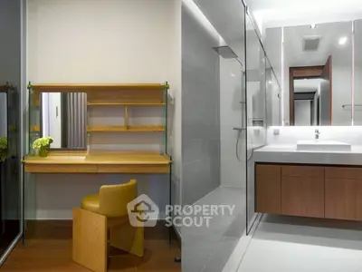 Modern bathroom with sleek vanity and glass shower enclosure