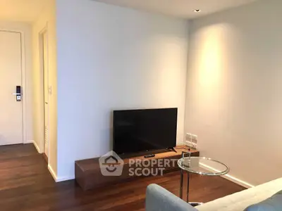 Modern living room with sleek TV setup and wooden flooring