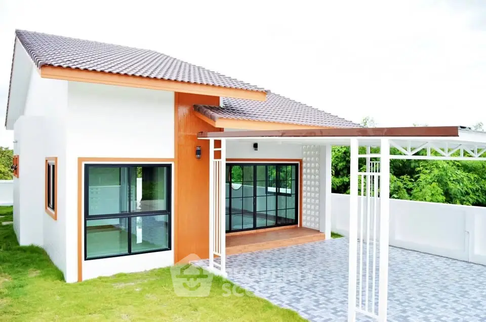 Modern single-story house with large windows and spacious driveway