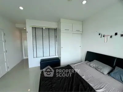 Modern bedroom with sleek design and ample natural light