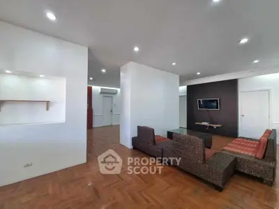 Spacious modern living room with stylish furniture and wooden flooring