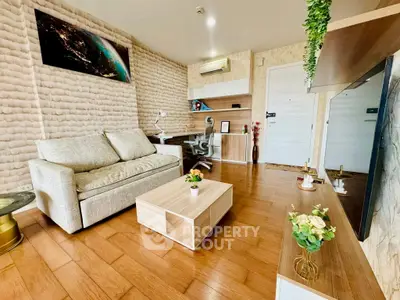 Stylish living room with modern decor, cozy sofa, and wooden flooring, perfect for relaxation and entertainment.