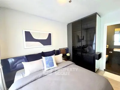 Modern bedroom with sleek black wardrobe and stylish decor