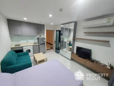 Modern studio apartment with compact kitchen and cozy living area