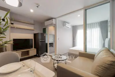 Modern open-plan living room with kitchen and bedroom in a cozy apartment