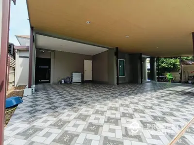 Spacious modern carport with stylish patterned flooring and ample space.