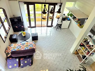 Spacious living room with modern decor and open kitchen layout