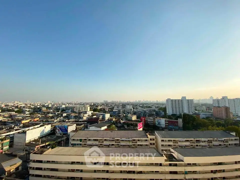 Stunning cityscape view from high-rise building showcasing urban skyline and clear blue sky.