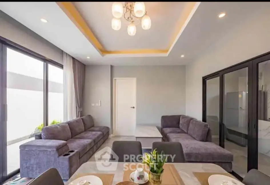 Spacious modern living room with elegant decor and large windows