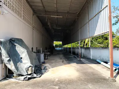 Spacious covered outdoor storage area with ample natural light and high ceiling.
