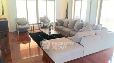 Spacious living room with plush sectional sofa and modern decor, perfect for relaxation and entertaining.