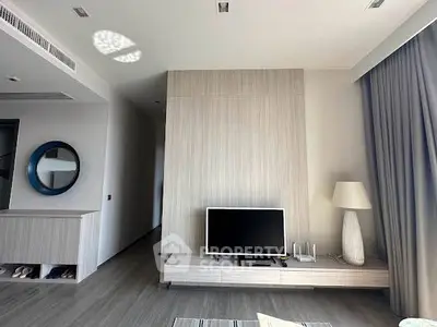Modern living room with sleek TV unit and stylish decor in a contemporary apartment.