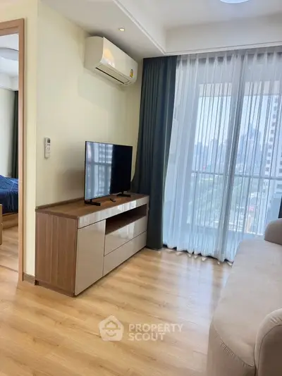Modern living room with TV, air conditioning, and city view from large windows.