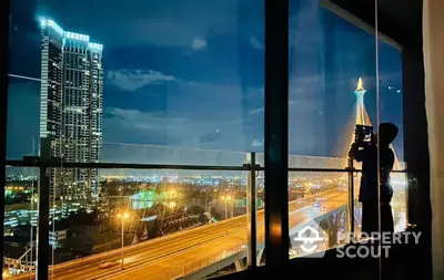 Stunning cityscape view from high-rise apartment with floor-to-ceiling windows