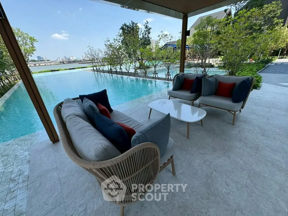 Luxurious poolside seating area with stunning city view, perfect for relaxation and entertaining.