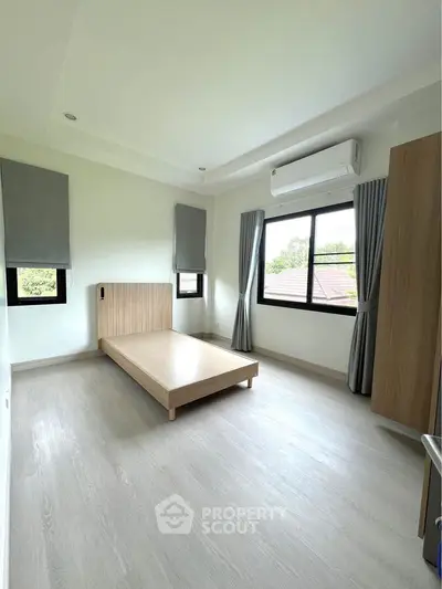 Modern minimalist bedroom with large windows and air conditioning