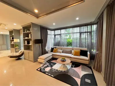 Spacious modern living room with large windows and stylish decor