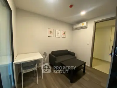 Cozy living room with modern furniture and air conditioning in a compact apartment.