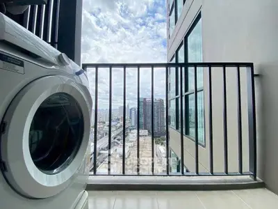 Modern apartment balcony with washing machine and city view, perfect for urban living.
