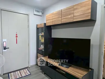 Modern living room with sleek TV unit and stylish wooden cabinets