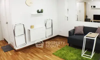 Modern living room with sleek design, wooden flooring, and cozy seating area.