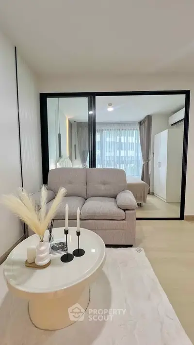 Modern living room with cozy sofa and stylish decor in a contemporary apartment.