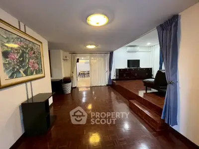 Spacious living room with wooden flooring and elegant decor